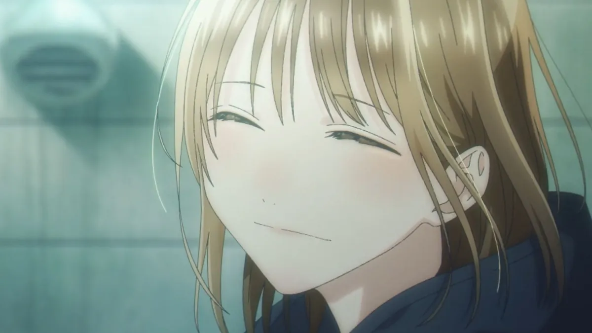Chinatsu smiles with her eyes closed and her head tilted, her light brown hair falling across her face, in a still from Blue Box season 2, episode 2