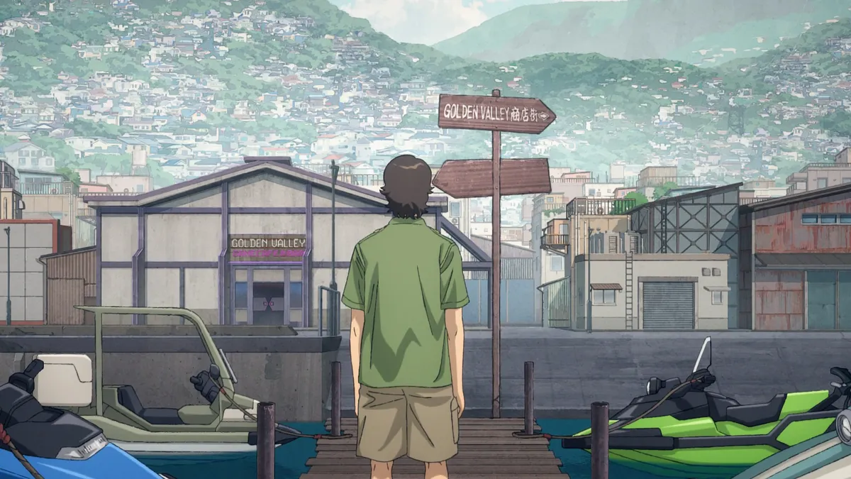 A boy in a green shirt and shorts stands on a wooden pier beside moored jet skis, looking at a harbour town with a signpost for Golden Valley and hills of houses behind it, in a still from DARK MACHINE THE ANIMATION episode 1