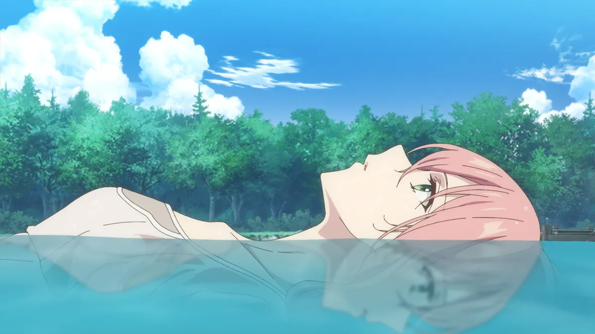 A girl with pink hair floats on her back in clear blue lake water under a bright sky with a line of green trees behind her, in a still from Hello, I Am a Witch and My Crush Wants Me to Make a Love Potion! episode 2
